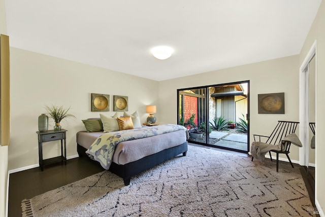 bedroom with baseboards, access to outside, and wood finished floors