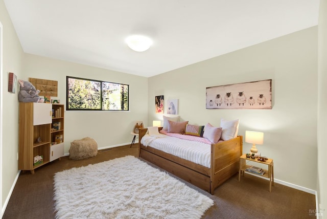 bedroom featuring carpet floors and baseboards