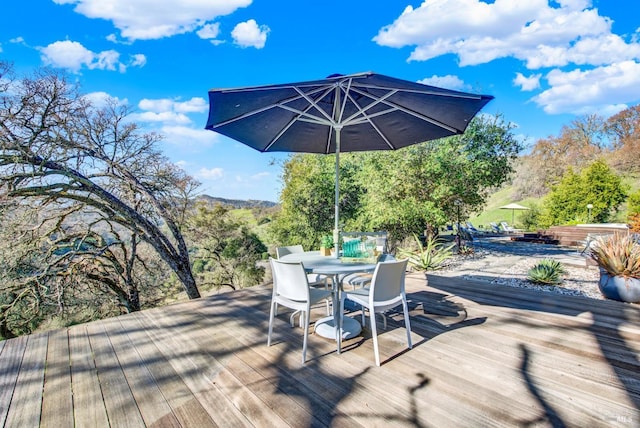 wooden deck with outdoor dining area