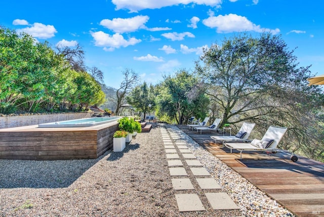 view of property's community featuring a hot tub