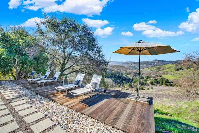 exterior space with a deck with mountain view