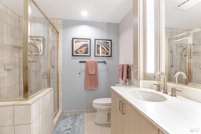 bathroom featuring vanity, an enclosed shower, tile patterned flooring, and toilet