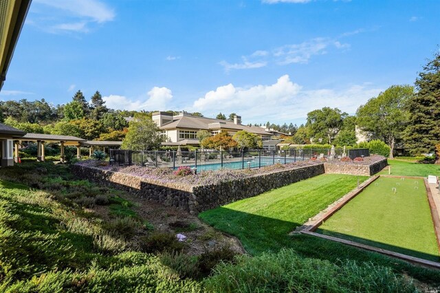 exterior space featuring a pool and a lawn