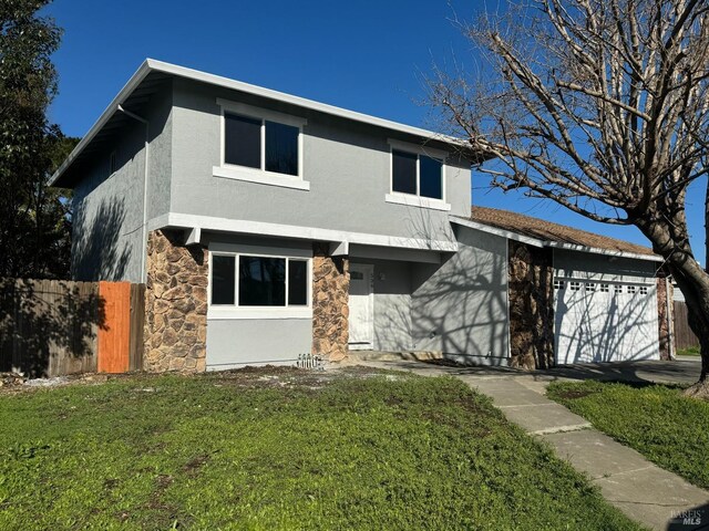 view of front of house featuring a garage and a front lawn