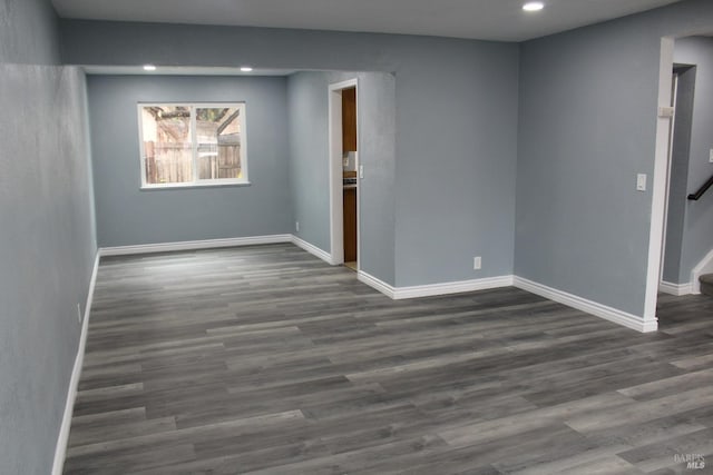 unfurnished room featuring dark wood-type flooring