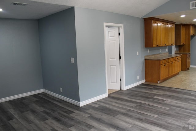 kitchen with lofted ceiling and hardwood / wood-style floors