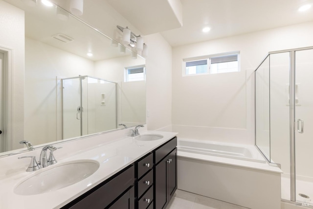 bathroom featuring a garden tub, a sink, and a shower stall