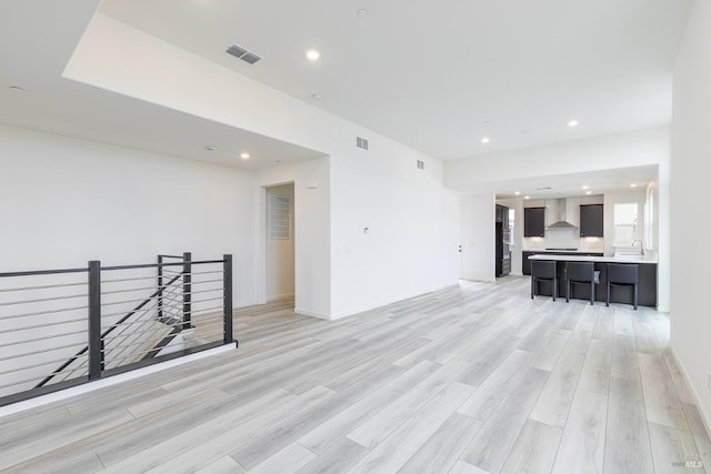 empty room featuring recessed lighting, visible vents, and light wood-style floors