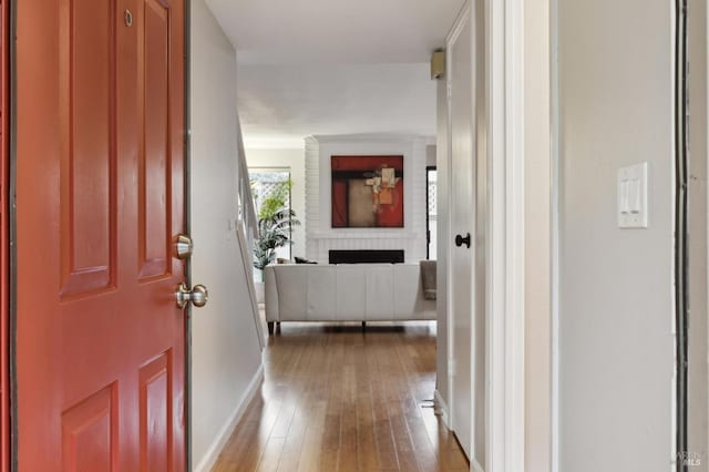 hall with hardwood / wood-style floors