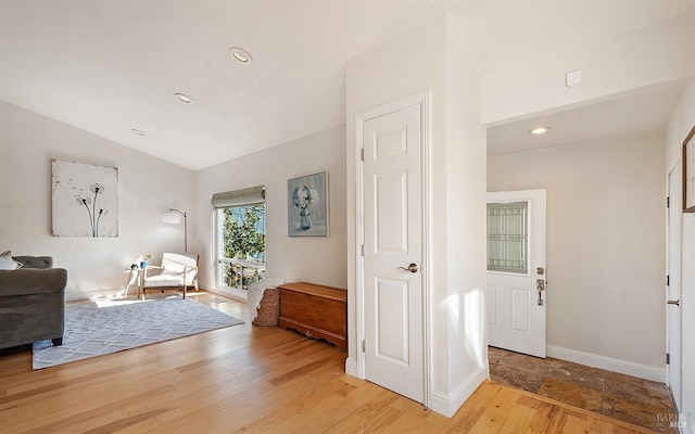 interior space featuring lofted ceiling and hardwood / wood-style floors