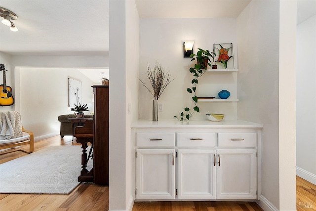 hallway with light hardwood / wood-style flooring