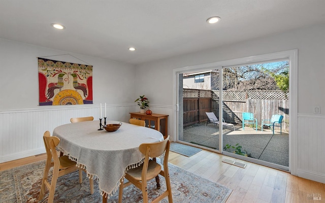 dining space with hardwood / wood-style flooring