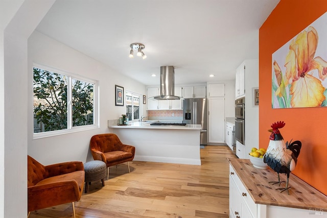 kitchen featuring butcher block counters, white cabinets, island exhaust hood, stainless steel fridge with ice dispenser, and kitchen peninsula