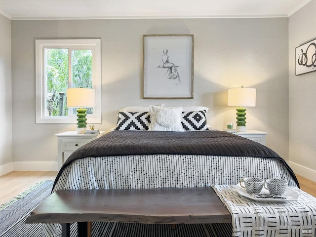 bedroom with hardwood / wood-style flooring and ornamental molding