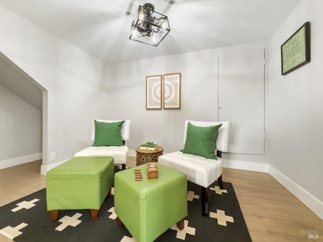 living area featuring baseboards and wood finished floors