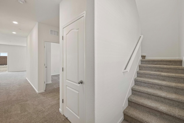 stairs with carpet, visible vents, baseboards, and recessed lighting