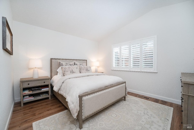 bedroom with hardwood / wood-style floors and vaulted ceiling