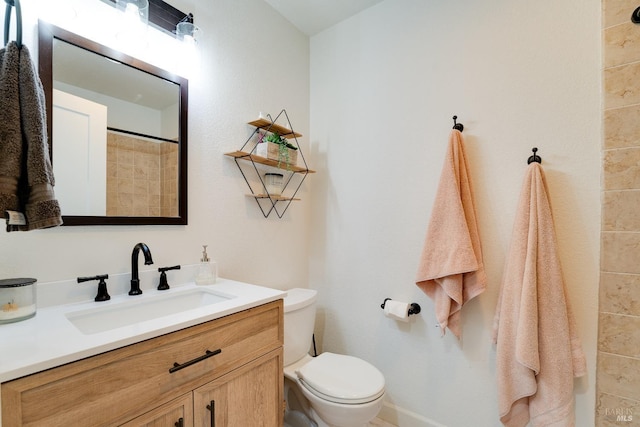 bathroom with vanity, walk in shower, and toilet