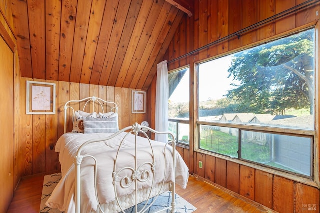 bedroom with vaulted ceiling, wood-type flooring, wooden ceiling, and wooden walls