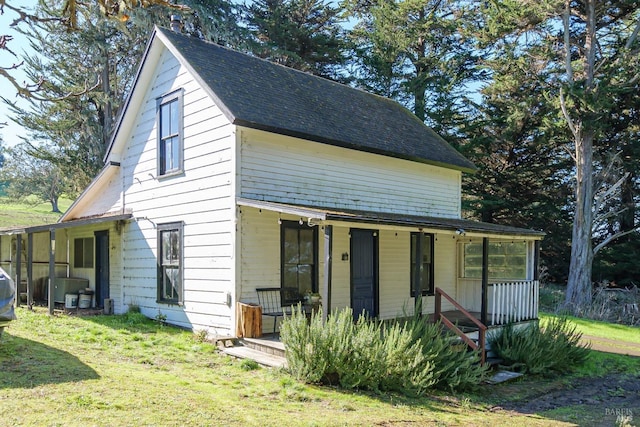 exterior space with a porch and a yard