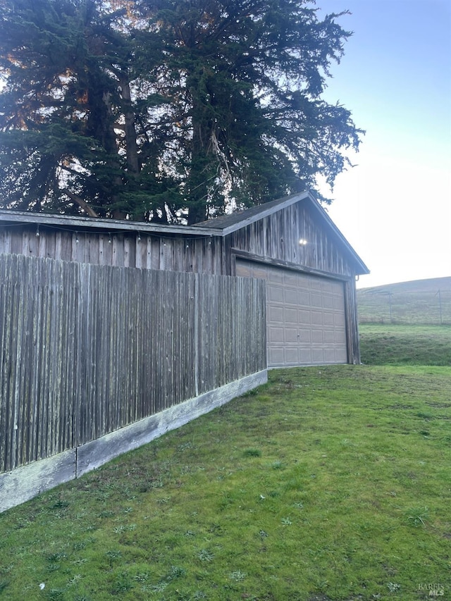 garage featuring a lawn