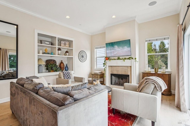 living room with crown molding and light hardwood / wood-style floors