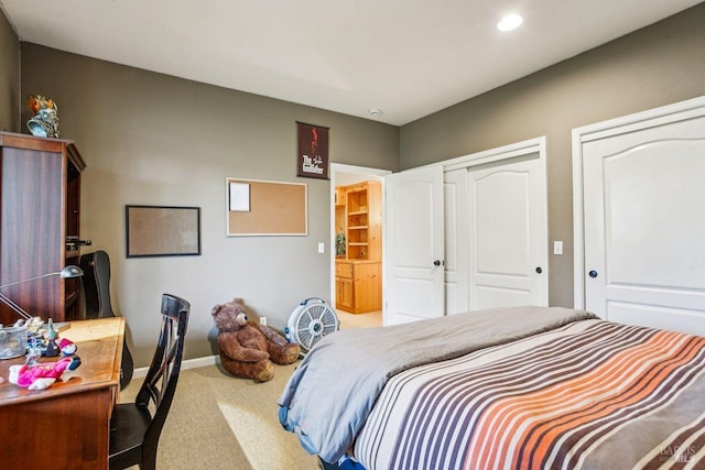 bedroom featuring multiple closets and carpet flooring