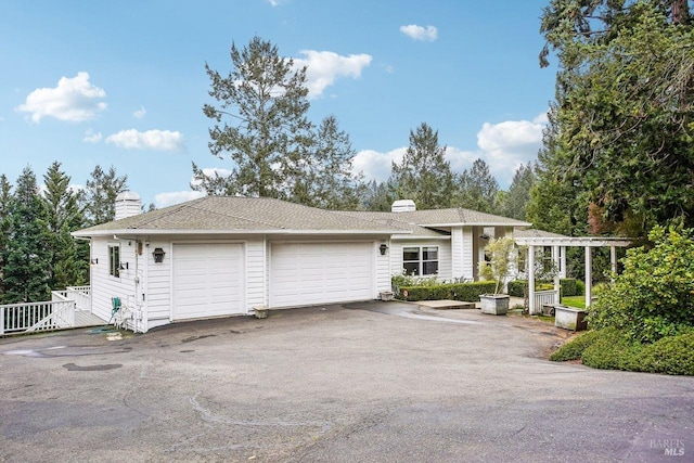 single story home with a garage and a pergola