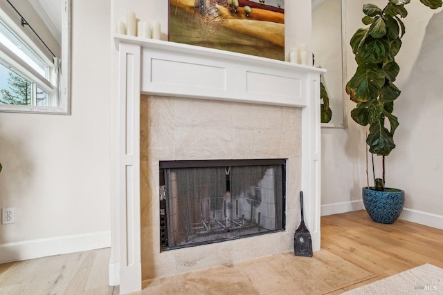 interior details with hardwood / wood-style floors and a premium fireplace