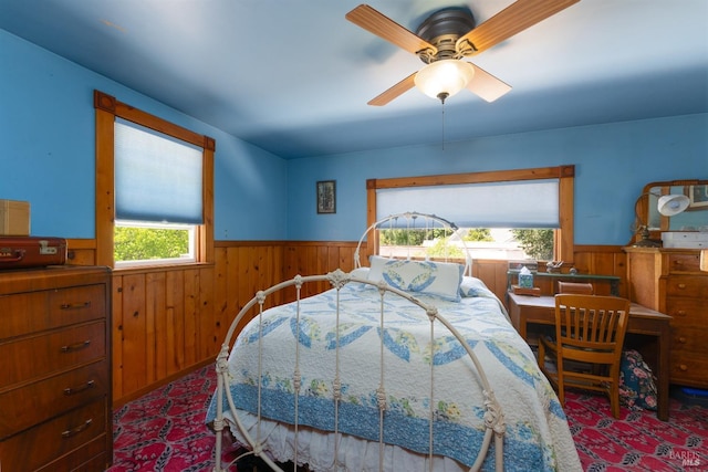 carpeted bedroom with wood walls