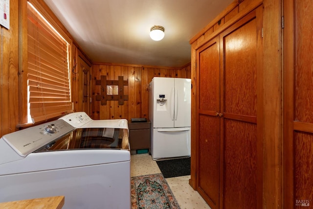 washroom with wooden walls and washer and clothes dryer