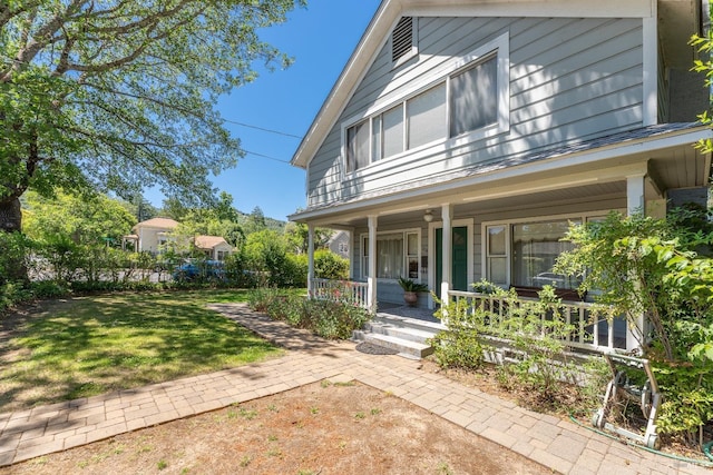 exterior space with a front lawn and a porch