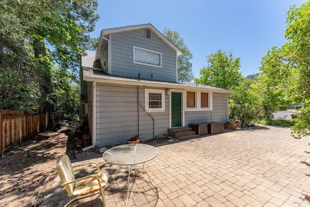 rear view of property featuring a patio area