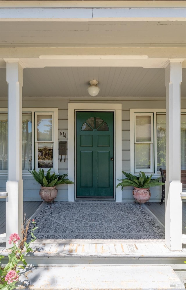 view of exterior entry featuring a porch