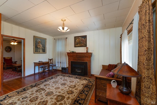 living room with dark wood-type flooring and a fireplace