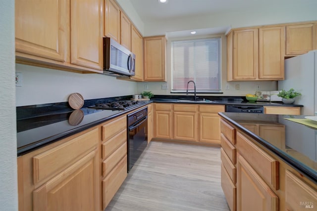 kitchen featuring sink, light hardwood / wood-style flooring, light brown cabinets, and black appliances