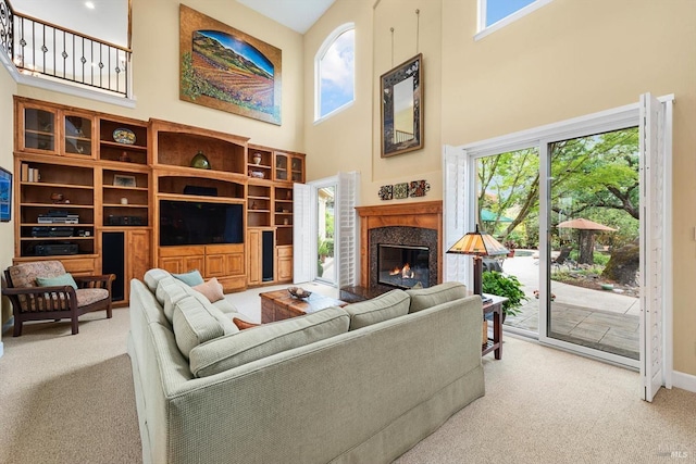 dining space featuring a raised ceiling, light hardwood / wood-style flooring, and ornate columns