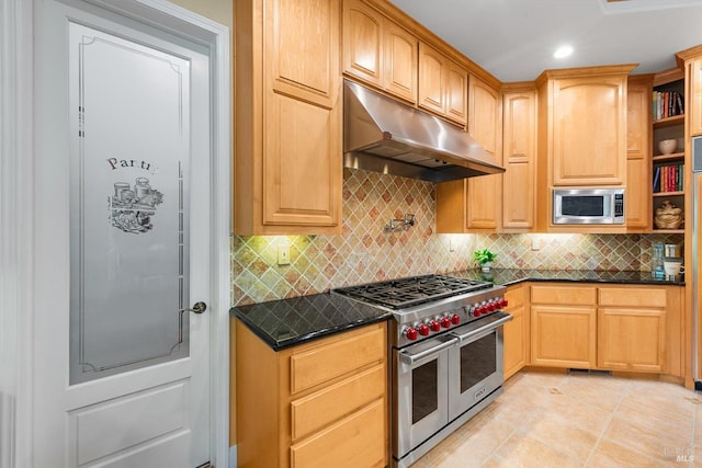 kitchen featuring stainless steel appliances, tasteful backsplash, light tile patterned flooring, and dark stone counters