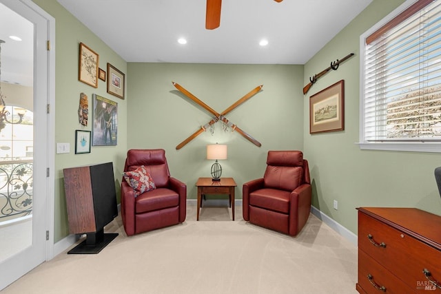 sitting room featuring ceiling fan and light colored carpet