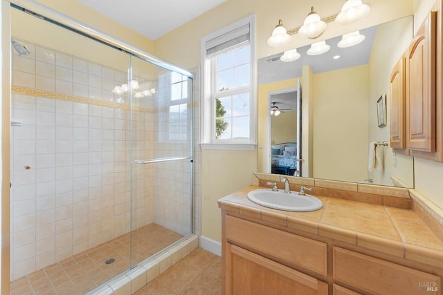 bathroom with vanity, an enclosed shower, and tile patterned floors