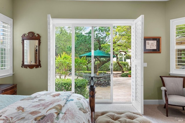 bedroom with carpet flooring and access to exterior