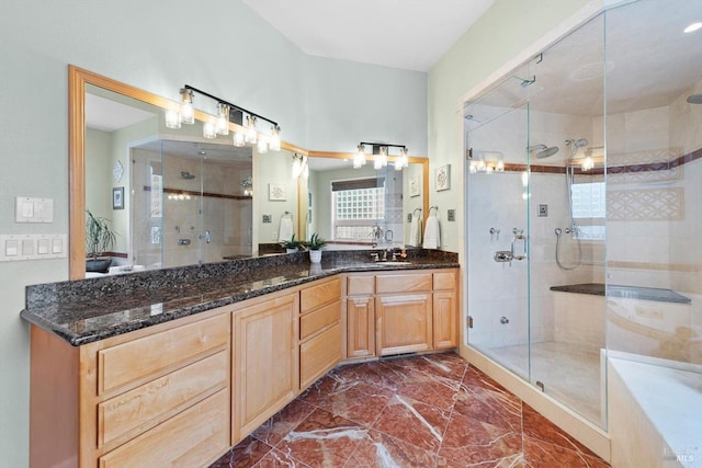 bathroom with a shower with door and vanity