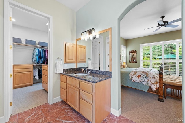 bathroom with ceiling fan and vanity