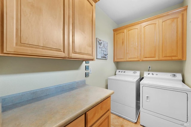 washroom featuring washing machine and dryer and cabinets