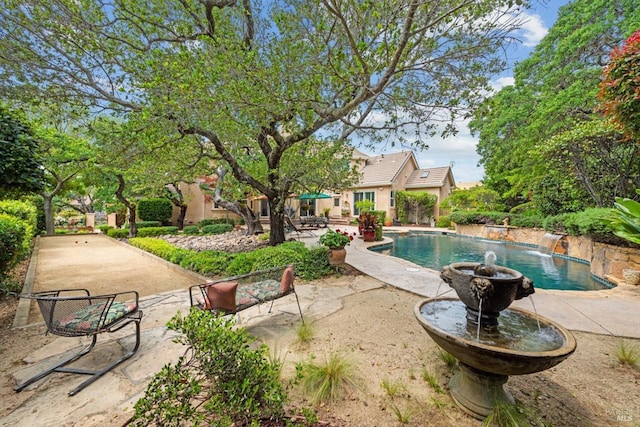 view of pool with a patio and pool water feature