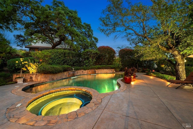 view of pool featuring an in ground hot tub and a patio area