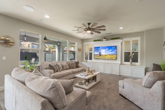 carpeted living area featuring recessed lighting, ceiling fan, and visible vents