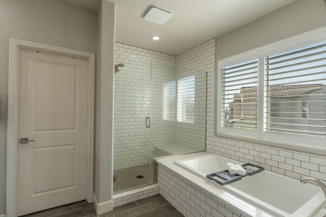 full bathroom with recessed lighting, a shower stall, wood finished floors, and a garden tub