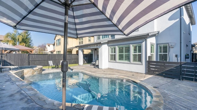 view of pool with a patio and an in ground hot tub