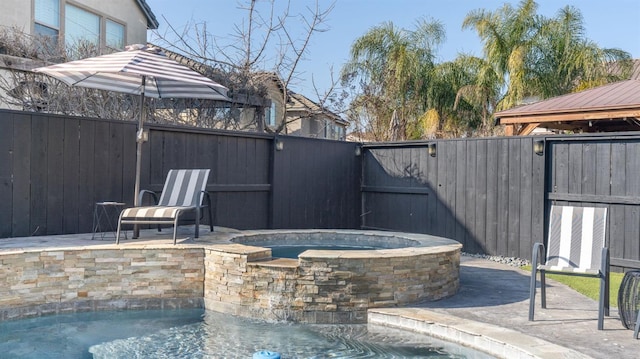 view of patio featuring a pool with hot tub